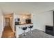 Well-lit kitchen features white cabinets, black appliances, and marble countertop with barstool seating at 1020 15Th St # 20F, Denver, CO 80202
