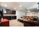 Spacious basement with a comfortable leather sofa, entertainment center, and wet bar at 57 Mc Intyre Cir, Golden, CO 80401