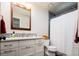 Bright bathroom featuring modern vanity, decorative mirror, and a shower with a white curtain at 57 Mc Intyre Cir, Golden, CO 80401