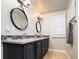 Well-lit bathroom showcasing double sinks, decorative mirrors, and stylish wall lighting at 57 Mc Intyre Cir, Golden, CO 80401