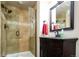 Tiled bathroom featuring glass shower door, and black granite vanity at 57 Mc Intyre Cir, Golden, CO 80401