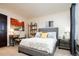 Comfortable bedroom with a desk, artwork, and a plush upholstered bed at 57 Mc Intyre Cir, Golden, CO 80401