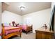 Simple ' bedroom featuring twin beds, wood furnishings and a neutral carpet at 57 Mc Intyre Cir, Golden, CO 80401