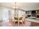 Cozy dining area that leads to living room, featuring large windows and modern light fixture at 57 Mc Intyre Cir, Golden, CO 80401