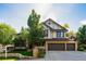 Charming home with a three-car garage, lush landscaping, and a well-maintained front yard at 57 Mc Intyre Cir, Golden, CO 80401