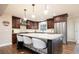 Bright eat-in kitchen boasts stainless appliances, dark wood cabinets, and granite counters at 57 Mc Intyre Cir, Golden, CO 80401