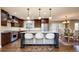 Bright eat-in kitchen features stainless appliances, dark wood cabinets, eat-in island and dining area at 57 Mc Intyre Cir, Golden, CO 80401