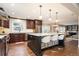 Open-concept kitchen boasts stainless appliances, dark wood cabinets, and eat-in island at 57 Mc Intyre Cir, Golden, CO 80401