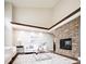 Bright living room featuring a stone fireplace, vaulted ceilings, and modern white furniture at 57 Mc Intyre Cir, Golden, CO 80401
