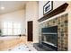 Relaxing bathroom featuring a soaking tub, tiled fireplace, and window with wooden shutters for natural light at 57 Mc Intyre Cir, Golden, CO 80401