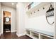 Well-organized mud room with built-in bench, cubbies, hooks, and convenient access to a half bathroom at 57 Mc Intyre Cir, Golden, CO 80401