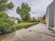 Spacious backyard with a concrete patio, flowers, green grass, shed, and wooden fence at 5339 S Windermere St, Littleton, CO 80120