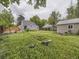 Expansive backyard with green grass, trees, wooden fence, and a storage shed at 5339 S Windermere St, Littleton, CO 80120