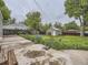 View of backyard featuring blue flowers, a grassy area, a storage shed, and a concrete patio at 5339 S Windermere St, Littleton, CO 80120