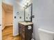 Cozy bathroom with a classic vanity, lighting, and a toilet at 5339 S Windermere St, Littleton, CO 80120