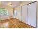 Bright bedroom with hardwood floors, closet, and natural light streaming through the window at 5339 S Windermere St, Littleton, CO 80120