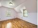 An upstairs bedroom with hardwood floors and a window letting in natural light at 5339 S Windermere St, Littleton, CO 80120