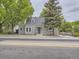 Charming home with gray siding, a well-manicured front yard, and mature trees at 5339 S Windermere St, Littleton, CO 80120