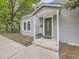 Charming home featuring a covered front door with glass detailing and light gray wood siding at 5339 S Windermere St, Littleton, CO 80120