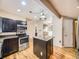 Contemporary kitchen featuring stainless steel appliances, granite countertops, and hardwood floors at 5339 S Windermere St, Littleton, CO 80120