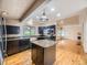 Well-lit kitchen featuring dark cabinetry, granite countertops, and a central island at 5339 S Windermere St, Littleton, CO 80120