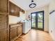 Functional laundry room with wood cabinets and direct access to the outdoors at 5339 S Windermere St, Littleton, CO 80120