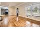 Spacious living room with glossy hardwood floors and direct access to the modern kitchen at 5339 S Windermere St, Littleton, CO 80120