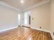 An airy living room boasting hardwood floors and white trim, leading to additional spaces at 5339 S Windermere St, Littleton, CO 80120