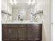 Well-lit bathroom with double vanity, wire storage and minimalist decor at 1846 Osprey Dr, Brighton, CO 80601
