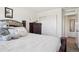 Comfortable bedroom featuring plush bedding, wood furniture, and neutral decor at 1846 Osprey Dr, Brighton, CO 80601
