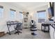 A bright, window-filled bedroom, with two desk spaces at 1846 Osprey Dr, Brighton, CO 80601