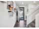 Bright foyer with wood floors, stylish decor, and convenient access to the staircase and living areas at 1846 Osprey Dr, Brighton, CO 80601