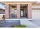 Inviting front porch with brick pillars, comfortable seating, and a welcoming entrance to the home at 1846 Osprey Dr, Brighton, CO 80601