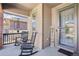 Cozy front porch with rocking chairs, brick accents, and a welcoming 'Welcome' sign by the front door at 1846 Osprey Dr, Brighton, CO 80601