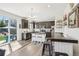 Modern kitchen featuring stainless steel appliances, island with seating, and access to outdoor dining at 1846 Osprey Dr, Brighton, CO 80601