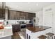 Modern kitchen with a stainless steel refrigerator, range, and island featuring a wooden countertop at 1846 Osprey Dr, Brighton, CO 80601