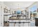 Kitchen island with wood countertop and white cabinets, leading into the living room and backyard at 1846 Osprey Dr, Brighton, CO 80601