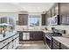 The modern kitchen is equipped with stainless steel appliances and an outdoor view through a sliding glass door at 1846 Osprey Dr, Brighton, CO 80601