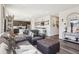 An open floor plan of living room features modern decor with an adjacent kitchen and bar area at 1846 Osprey Dr, Brighton, CO 80601