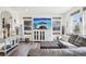 Cozy living room with hardwood floors, large TV, comfortable seating, and great natural lighting at 1846 Osprey Dr, Brighton, CO 80601