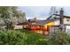 Expansive backyard featuring a well-maintained lawn, wooden deck, and flowering lilac bushes at 7290 Lamar Ct, Arvada, CO 80003