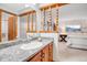 Bathroom features granite counters, wooden cabinets, and decorative wooden features at 7290 Lamar Ct, Arvada, CO 80003