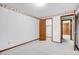 Empty bedroom with carpet flooring with view into closet and wood paneled space at 7290 Lamar Ct, Arvada, CO 80003