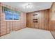 Cozy bedroom featuring vintage wallpaper and wood paneling with natural light at 7290 Lamar Ct, Arvada, CO 80003