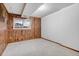 Cozy bedroom with wood paneling, natural light and carpeted floors at 7290 Lamar Ct, Arvada, CO 80003