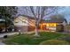 Charming two-story home with a well-manicured lawn and beautiful landscaping and an attached garage at 7290 Lamar Ct, Arvada, CO 80003
