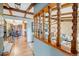 Home foyer featuring wood floors and exposed wood beams on the ceiling and an adjacent dining area at 7290 Lamar Ct, Arvada, CO 80003