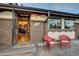 Inviting home entrance featuring red chairs on the front porch and a view into the well-lit foyer at 7290 Lamar Ct, Arvada, CO 80003