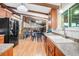 Bright kitchen featuring wood cabinets, stainless steel appliances, granite countertops, and hardwood floors at 7290 Lamar Ct, Arvada, CO 80003