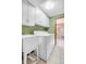 Functional laundry room with ample storage, modern washer/dryer and utility sink at 7290 Lamar Ct, Arvada, CO 80003